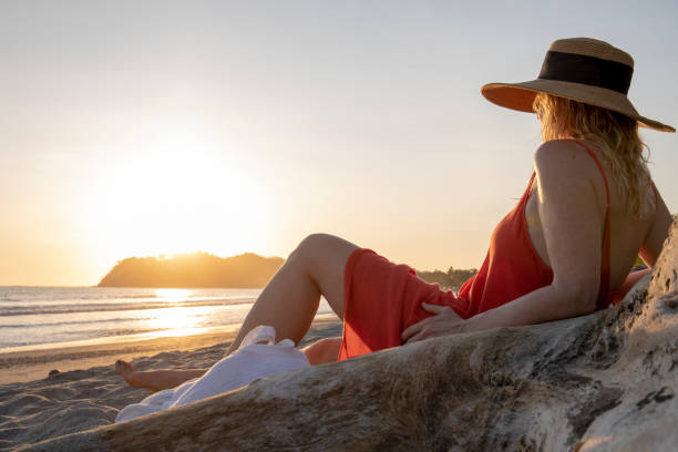 istock Woman relaxes on tropical beach 1214579118