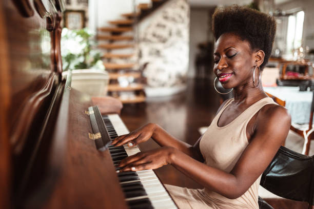 istock afro woman playing piano 1214579564