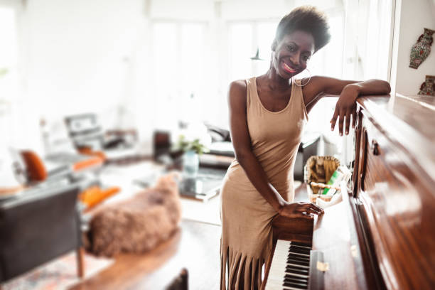 istock afro woman playing piano 1214579603