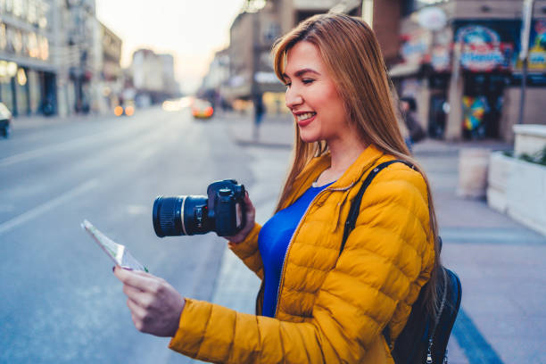 istock Tourist woman with camera exploring the city 1214579714