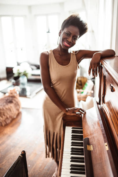 istock afro woman playing piano 1214580483