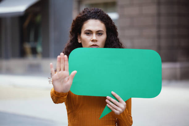 istock Young woman holding a chat bubble 1214582281
