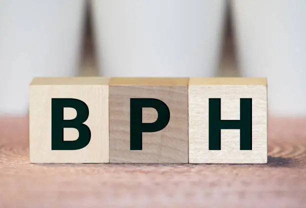 Photo of BPH Benign Prostatic Hyperplasia acronym on wooden background