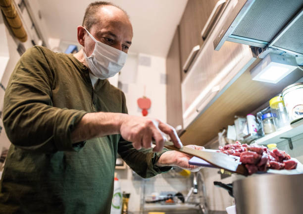 istock Man is cooking whit mask while covid 19 1214583977
