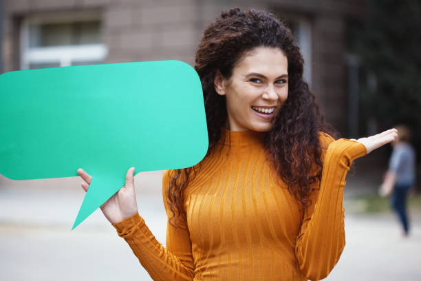 istock Young woman holding a chat bubble 1214585646