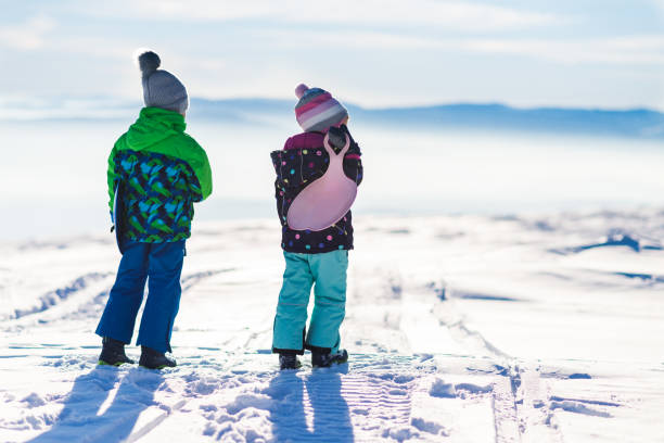 istock Happy kids enjoying winter snow 1214586952