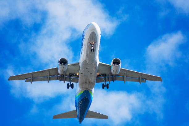 Alaska Airlines Airbus a320 aircraft with deployed landing gear preparing for landing at SJC airport - San Jose, California, USA - 2020
