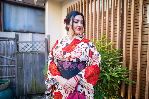 Caucasian woman standing in front of traditional Japanese restaurant