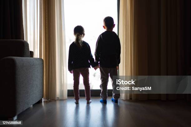 Looking Trough The Window Stock Photo - Download Image Now - Child, Sadness, Rear View