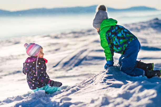 istock Happy kids enjoying winter snow 1214589085