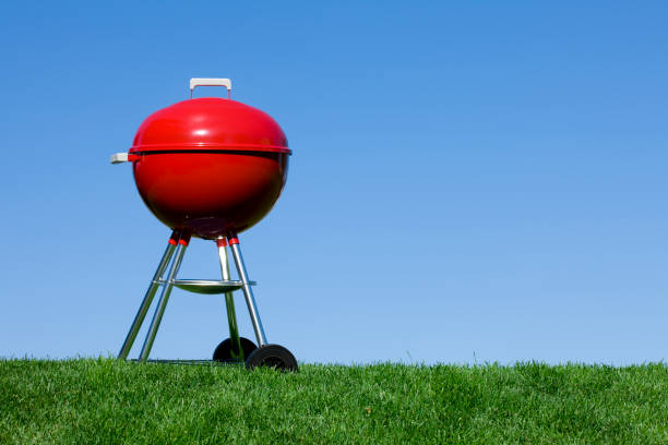istock Red Barbecue Grill against a Blue Sky 1214589103
