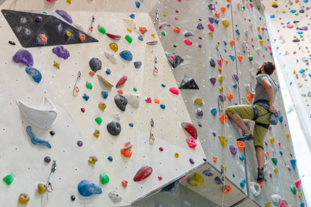 istock Young Man Indoor Rock Climbing 1214589641