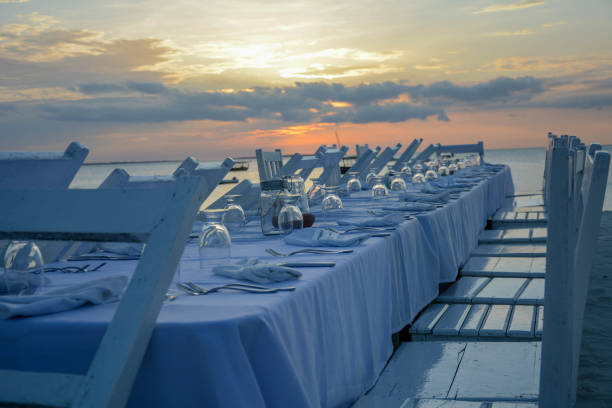 istock Elegant table for dinning on beach at sunset 1214589824