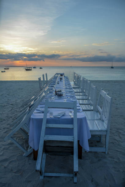istock Elegant table for dinning on beach at sunset 1214589925