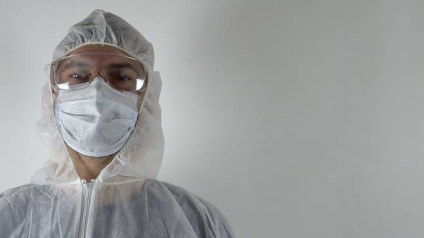 istock A man in a protective suit stands against a white wall 1214590031