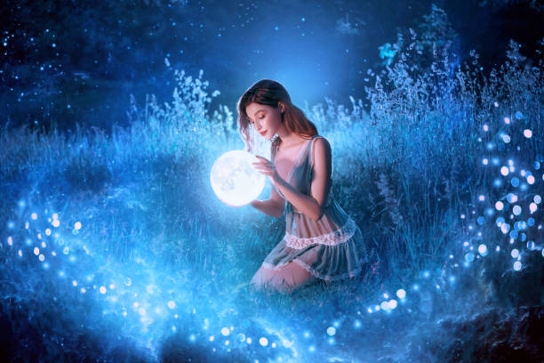 artwork fantasy young beautiful woman holds magical ball planet. night nature dark forest. mystic moon light magic universe outer space. backdrop fairy flying bright sparkle stars white fog blue grass - fairy forest fairy tale mist imagens e fotografias de stock