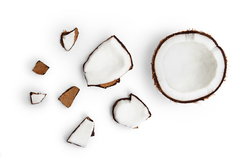 Coco entero y trozos de coco sobre fondo blanco photo
