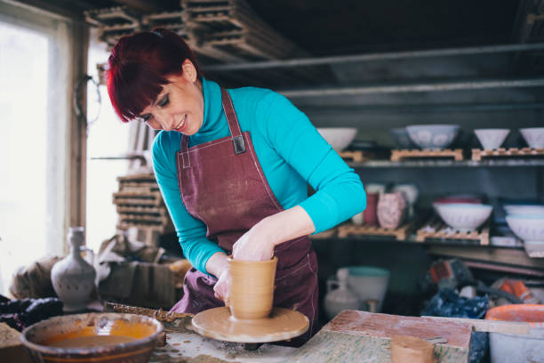 istock A Handsome Smiling Potter  Makes A Clay Pot On A Potter’s Wheel In A Workshop 1214593004