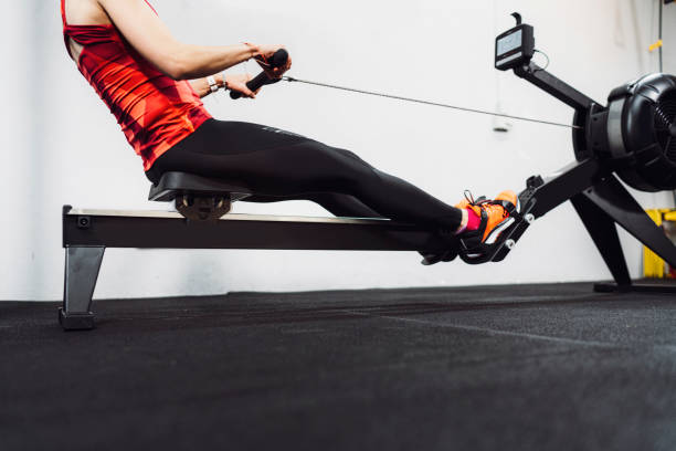istock Unrecognizable woman doing cardio on rowing machine 1214593049
