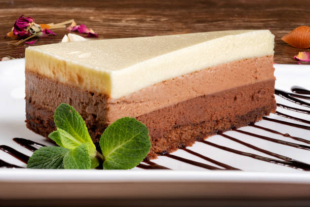 istock Piece of chocolate striped cake on a white plate. 1214593079