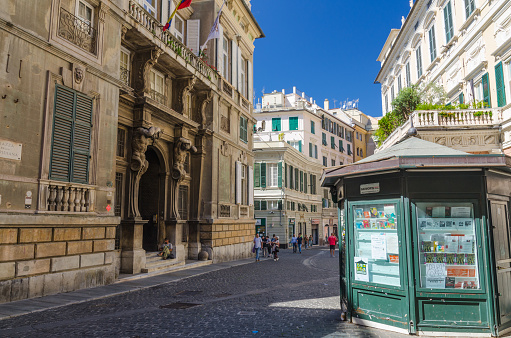 Genoa, Italy, September 11, 2018: Palace Palazzo Grimaldi della Meridiana, typical colorful buildings, old bookstall kiosk on Piazza della Meridiana square in historical centre of city Genova, Liguria
