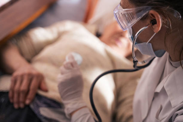istock Coronavirus protection. Female doctor home visit during the quarantine. 1214593241