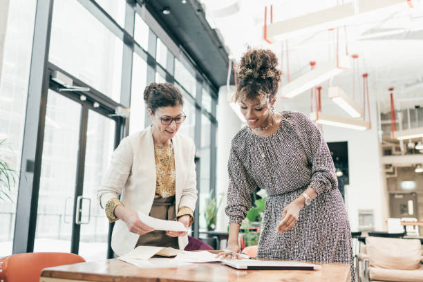 mature female owner during the meeting with young talent - speech recruitment technology young adult imagens e fotografias de stock