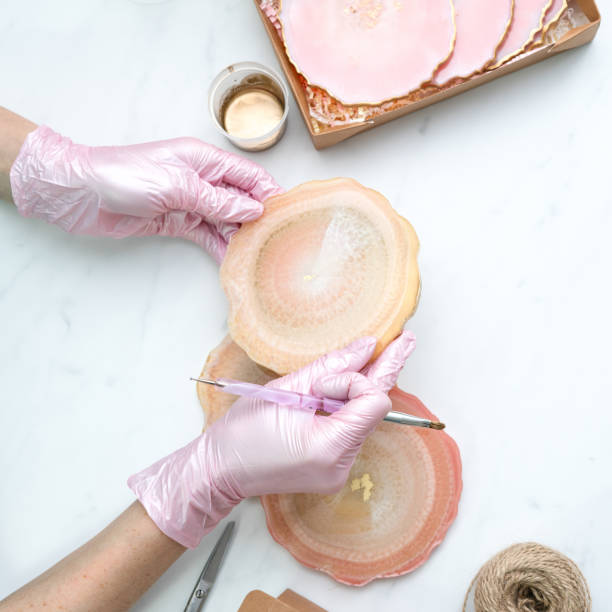 istock Creativity and craft. A young girl creates coasters from resin. Gift wrapping. Decorative packaging. Idea for business. Remote work, work at home. Art coasters. 1214593829