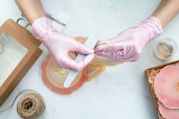 istock Creativity and craft. A young girl creates coasters from resin. Gift wrapping. Decorative packaging. Idea for business. Remote work, work at home. Art coasters. 1214593836