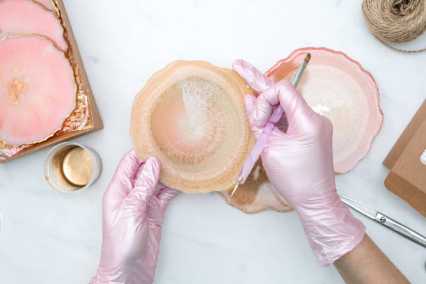 istock Creativity and craft. A young girl creates coasters from resin. Gift wrapping. Decorative packaging. Idea for business. Remote work, work at home. Art coasters. 1214593839