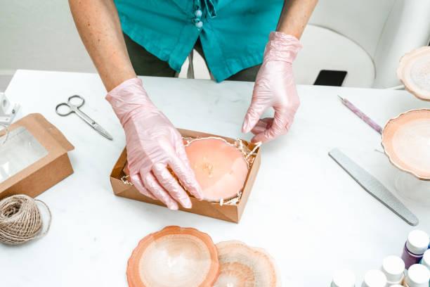 istock Creativity and craft. A young girl creates coasters from resin. Gift wrapping. Decorative packaging. Idea for business. Remote work, work at home. Art coasters. 1214593843