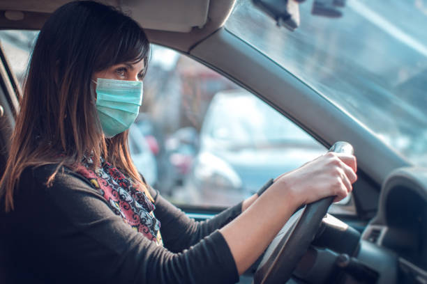 driving car with face mask - illness mask pollution car imagens e fotografias de stock