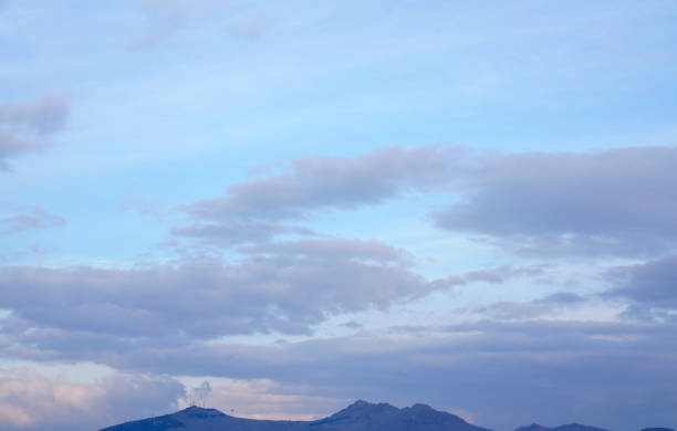 istock yellow and orange clouds at sunset. dramatic sky skyline background with mountain 1214598968