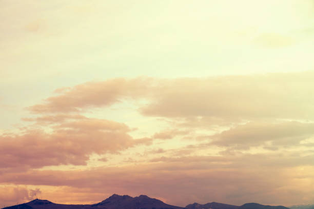 yellow and orange clouds at sunset. dramatic sky skyline background with mountain