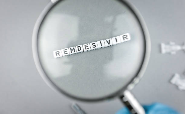Magnifying glass on alphabet dices with the word Remdesivir a possible treatment for Corona Virus Sars CoV 2 Covid 19 Magnifying glass on alphabet dices with the word Remdesivir a possible treatment for Corona Virus food and drug administration photos stock pictures, royalty-free photos & images