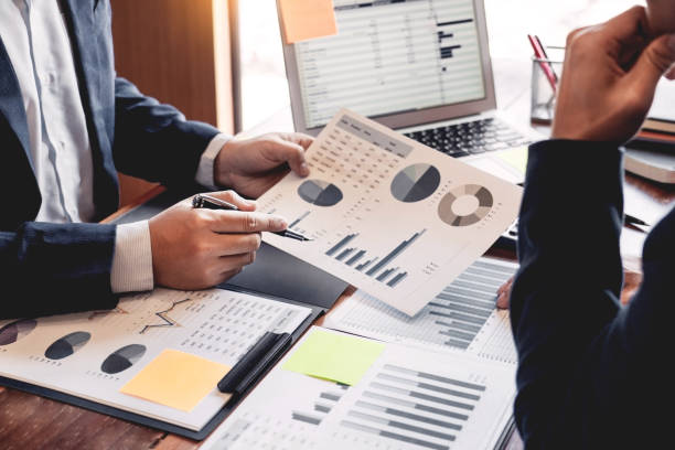 istock Business Corporate team brainstorming, Planning Strategy having a discussion Analysis investment researching with chart at office his desk documents and saving concept. 1214603342
