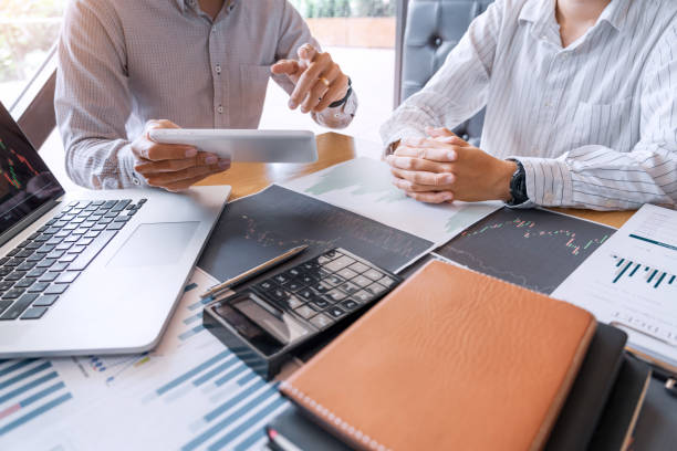 istock Working business man, team of broker or traders talking about forex on multiple computer screens of stock market invest trading financial graph charts data analysis 1214603388