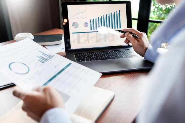 istock strategy analysis concept, Businessman working  financial Manager Researching Process accounting calculate analyse market graph data stock information review on the table in office. 1214604591