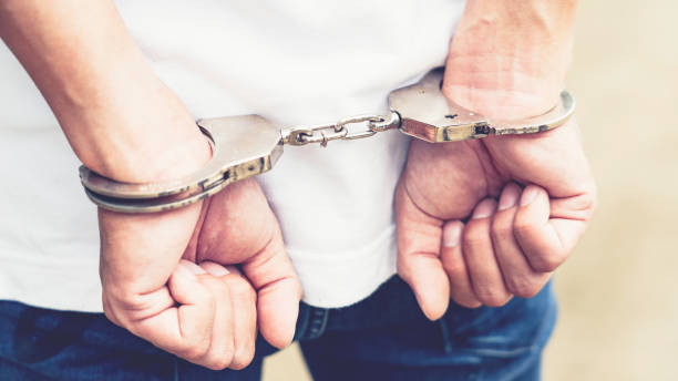 istock Prisoner male hands criminal with handcuffs 1214604655