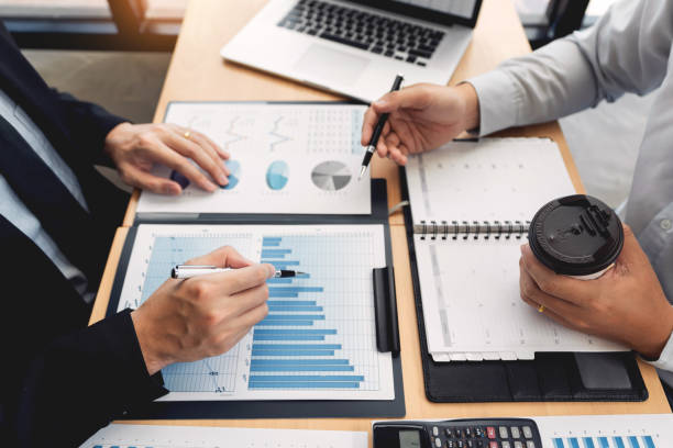 istock Business Corporate team brainstorming, Planning Strategy having a discussion Analysis investment researching with chart at office his desk documents and saving concept. 1214607470