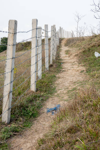 istock Barbed Wire Fence on a Hillside 1214610646