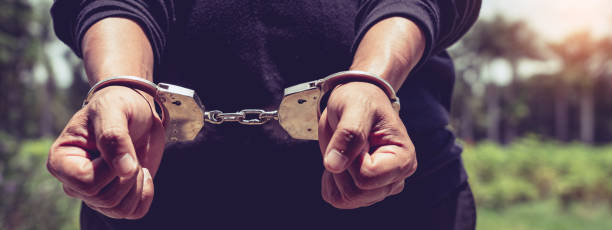 istock Prisoner male hands criminal with handcuffs 1214611883