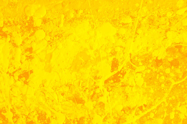 istock spots and splashes of yellow paint on a orange background. abstract saffron color pattern for decoration 1214615041