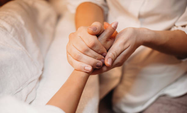 istock Caucasian masseur is massaging client's hand and prepare it for the next spa procedure 1214616172