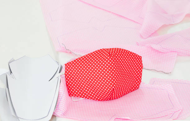 istock Close-up. mask fabric striped point red white homemade on table. prevent coronavirus or (Covid-2019) concept prophylaxis 1214619792