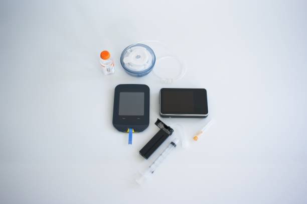 Insulin pump infusion set and blood glucose tester stock photo