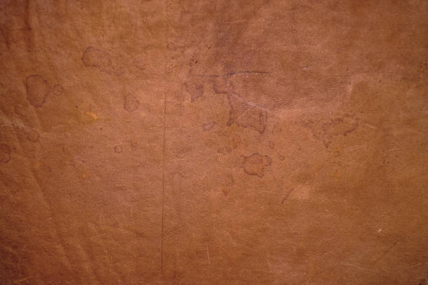 istock Texture of old brown worn antique leather with spots 1214621695