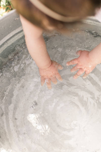 istock Baby Washing Hands in Water 1214622092