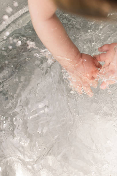 istock Baby Washing Hands in Water 1214622705