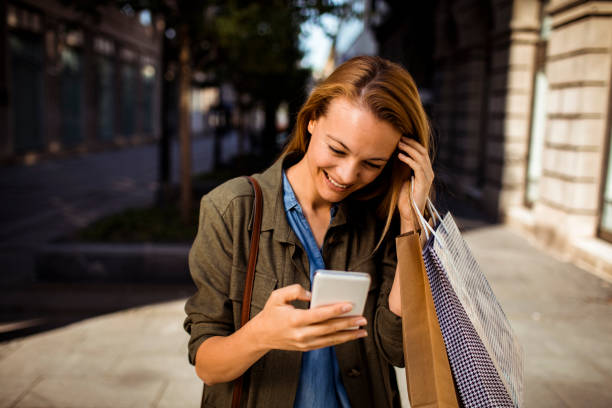 istock Young Lady shopping and using a Phone 1214622848